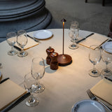 Dimmable cordless table lamp lit on a dark surface at night