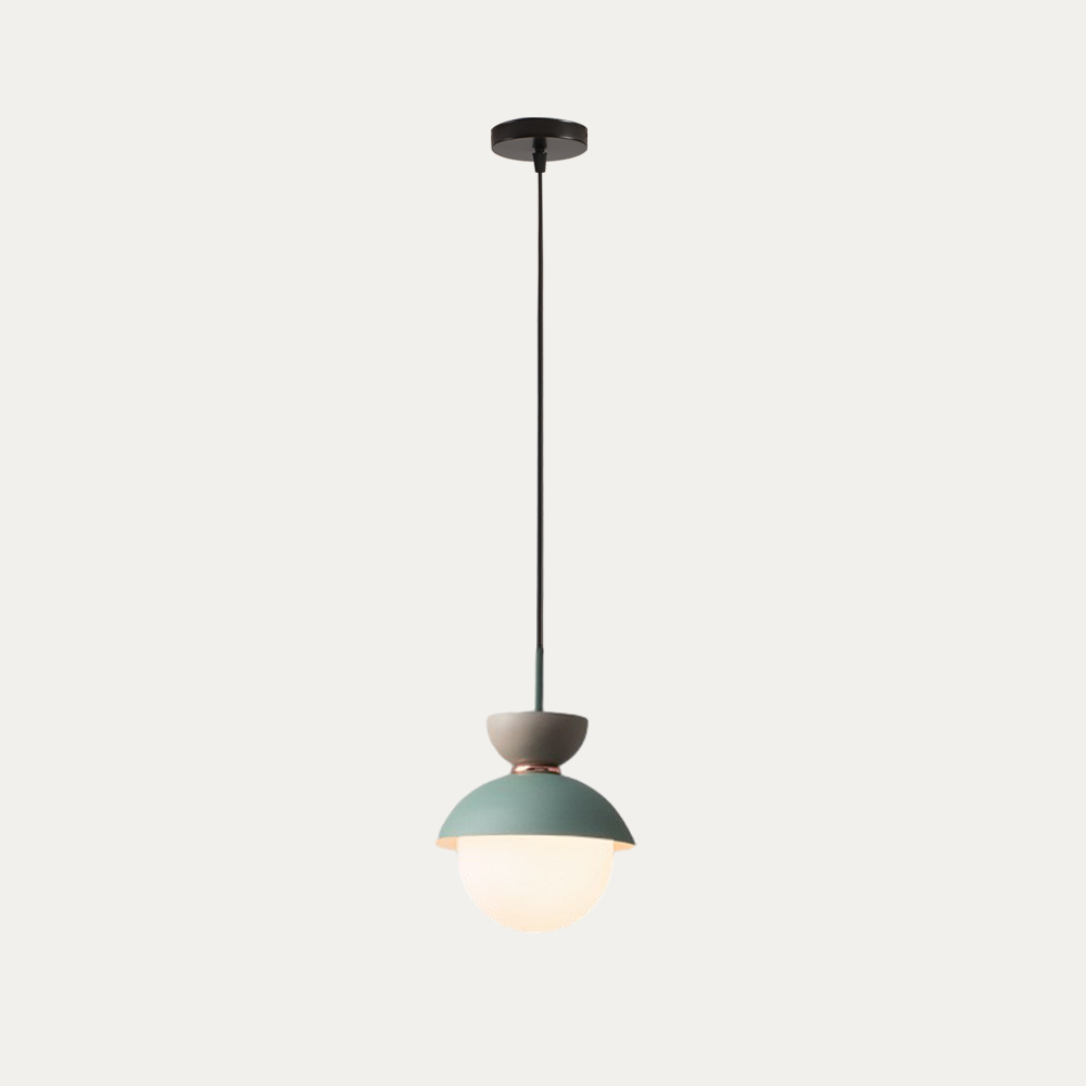 Light blue macaron pendant light shown lit in a modern interior setting
