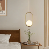 Black oval and round frame glass globe pendants above a wood coffee table