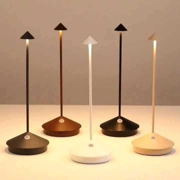 White rechargeable table lamp glowing warmly in a dim room