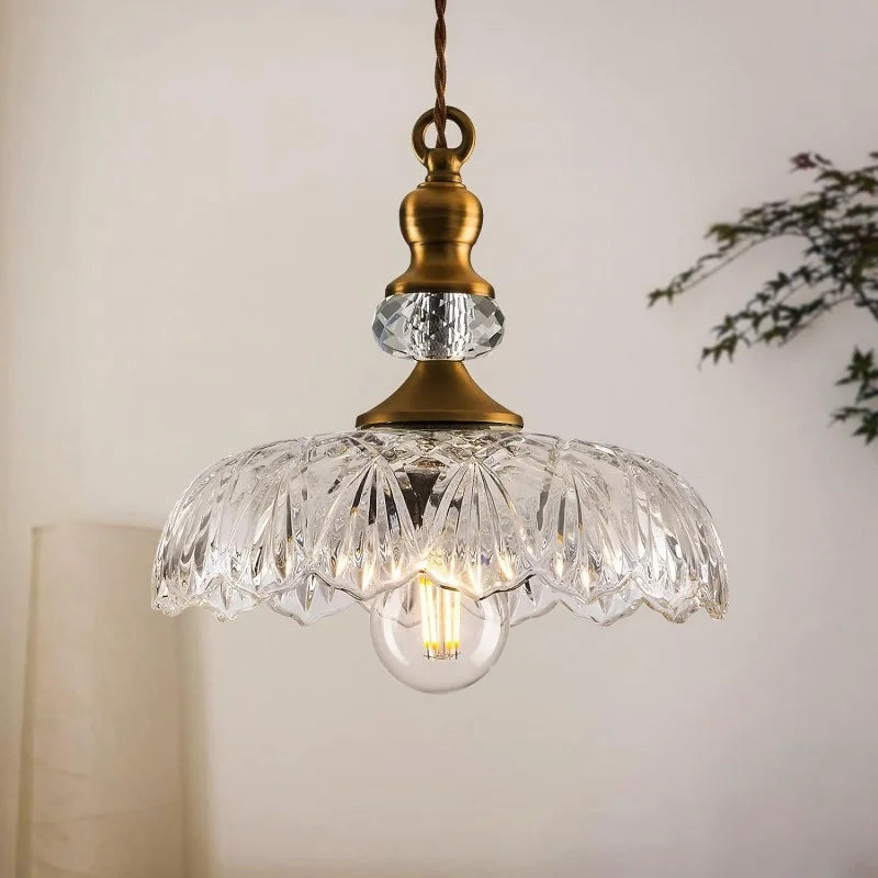 Green scalloped glass pendant light with brass hardware close up