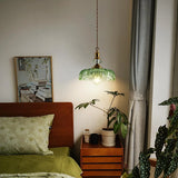Close view of the petal-edged glass shade on the brass pendant light