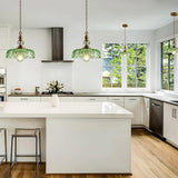Retro pendant light with green glass shade and turned brass body