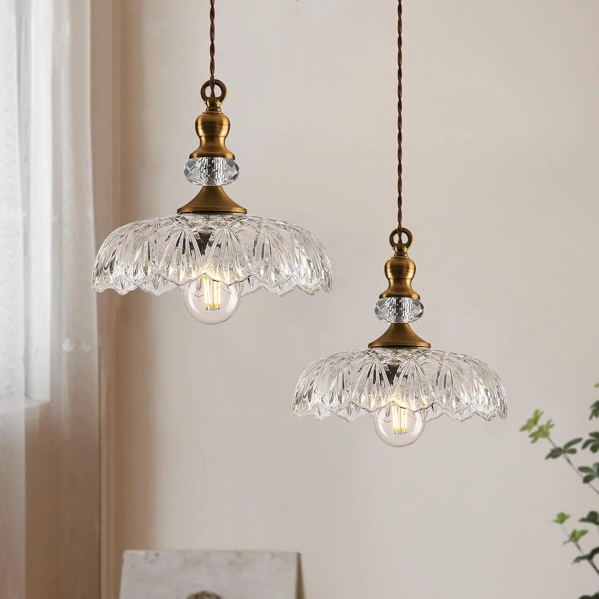 Underside view of the scalloped glass pendant shade and bulb socket
