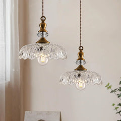 Underside view of the scalloped glass pendant shade and bulb socket