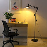 Black iron swing arm floor lamp shown against a plain studio background