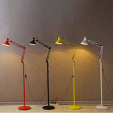Cone shade tilted down to aim task light onto a reading surface