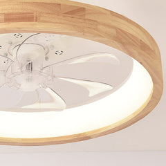 Angled shot of the round wood ceiling fan light against grey