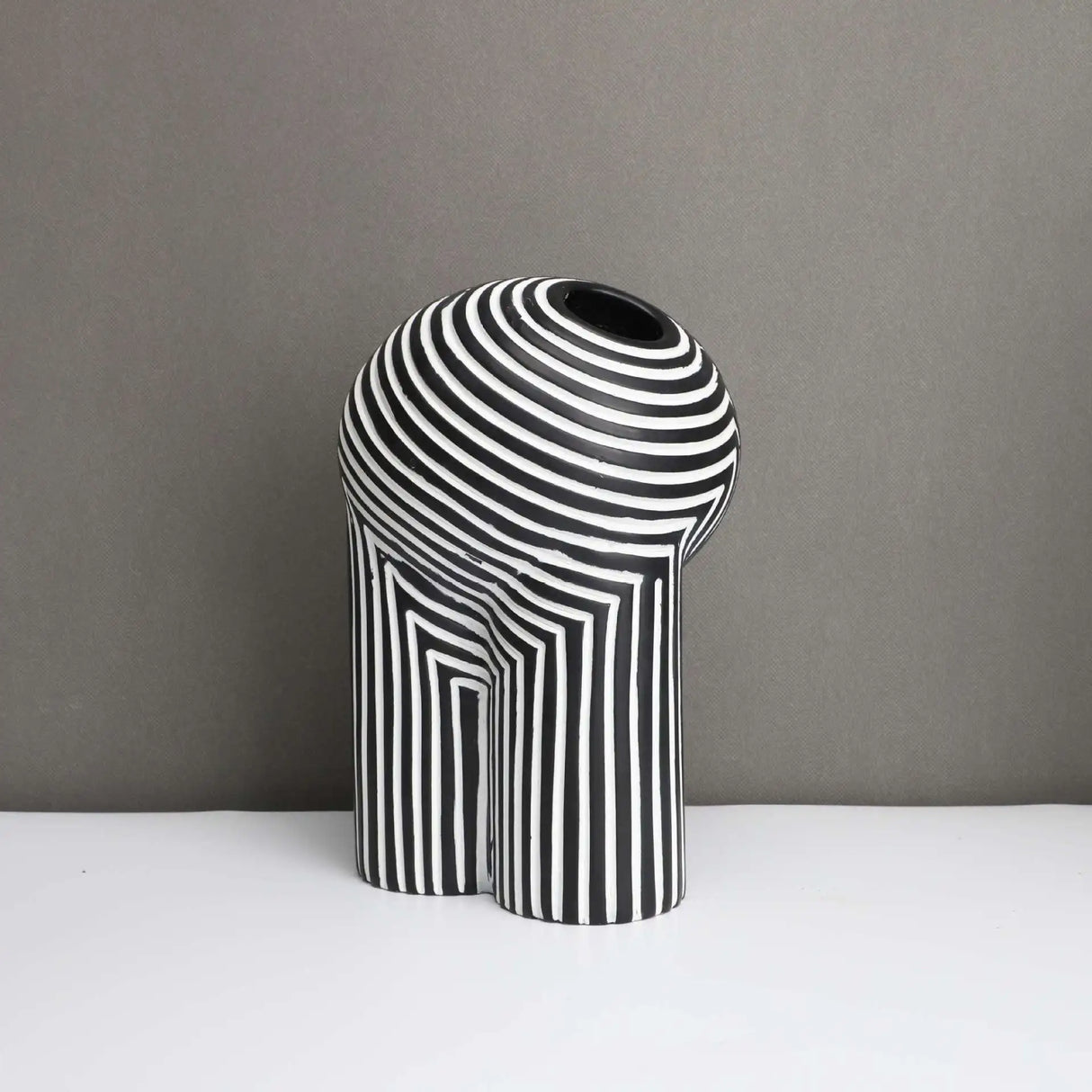 Black and white striped vase with modern geometric design