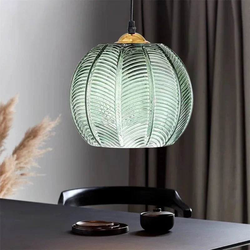 Close view of the green textured glass shade showing raised palm leaf detailing