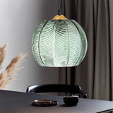 Close view of the green textured glass shade showing raised palm leaf detailing