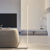 White corner floor lamp beside a houndstooth sofa and marble bench with television