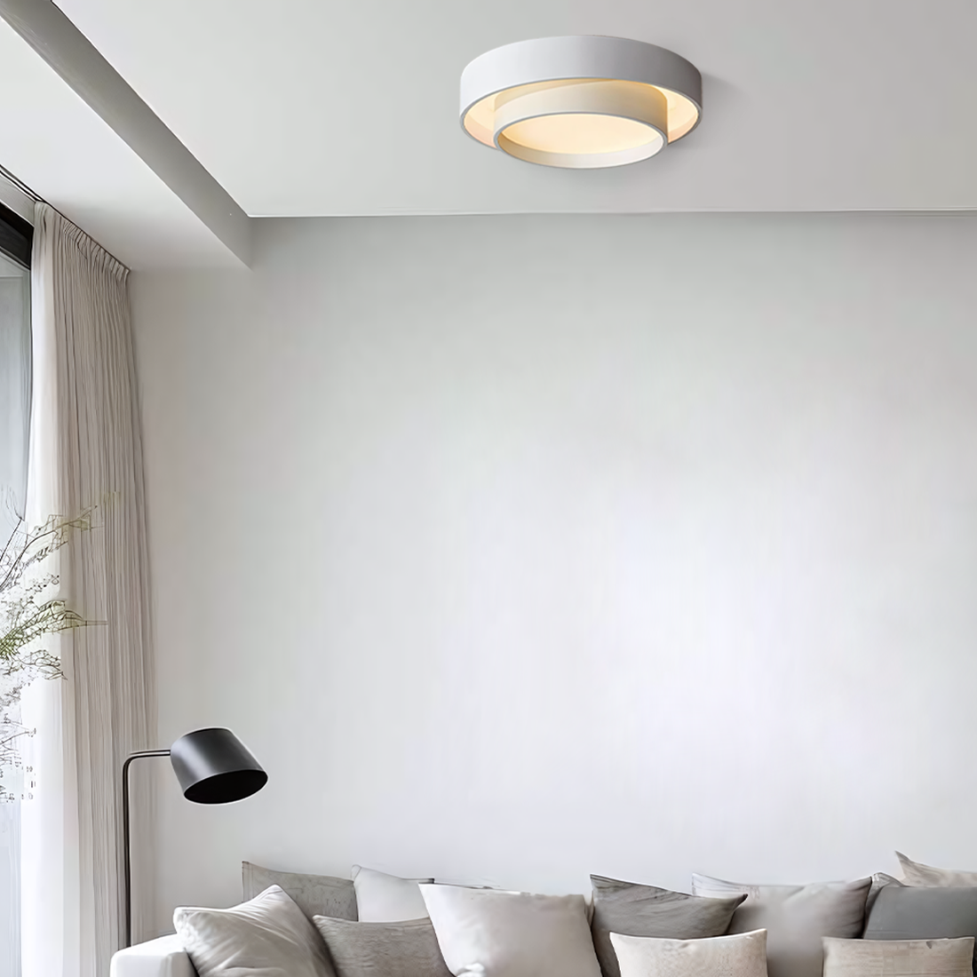 Disc ceiling light lit in a cool tone
