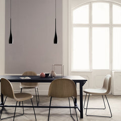 Teardrop pendant light lighting a calm neutral dining space