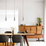 Teardrop pendant light hanging over a minimalist dining table