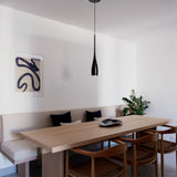 Water drop pendant light over a minimalist dining room table