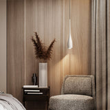 Water drop pendant light glowing in a minimalist living room