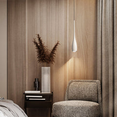 Water drop pendant light glowing in a minimalist living room