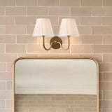 Pleated fabric wall sconce viewed from the side showing the shade taper, white shade angled view 13