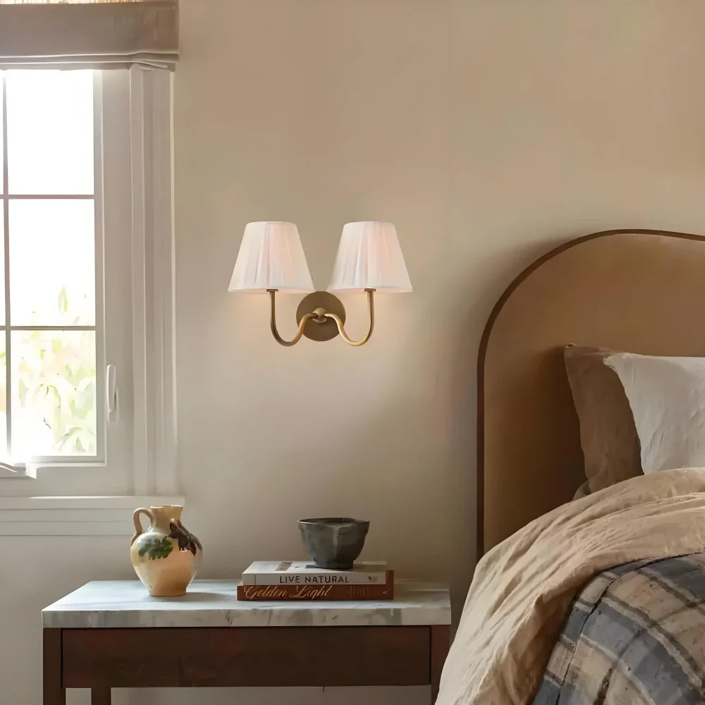 Close view of the pleated fabric shade and diffused warm light on the sconce, sage green shade catalogue image 20