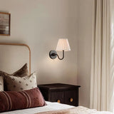 Pleated linen shade wall sconce shown against a plain studio background, red shade product shot 17