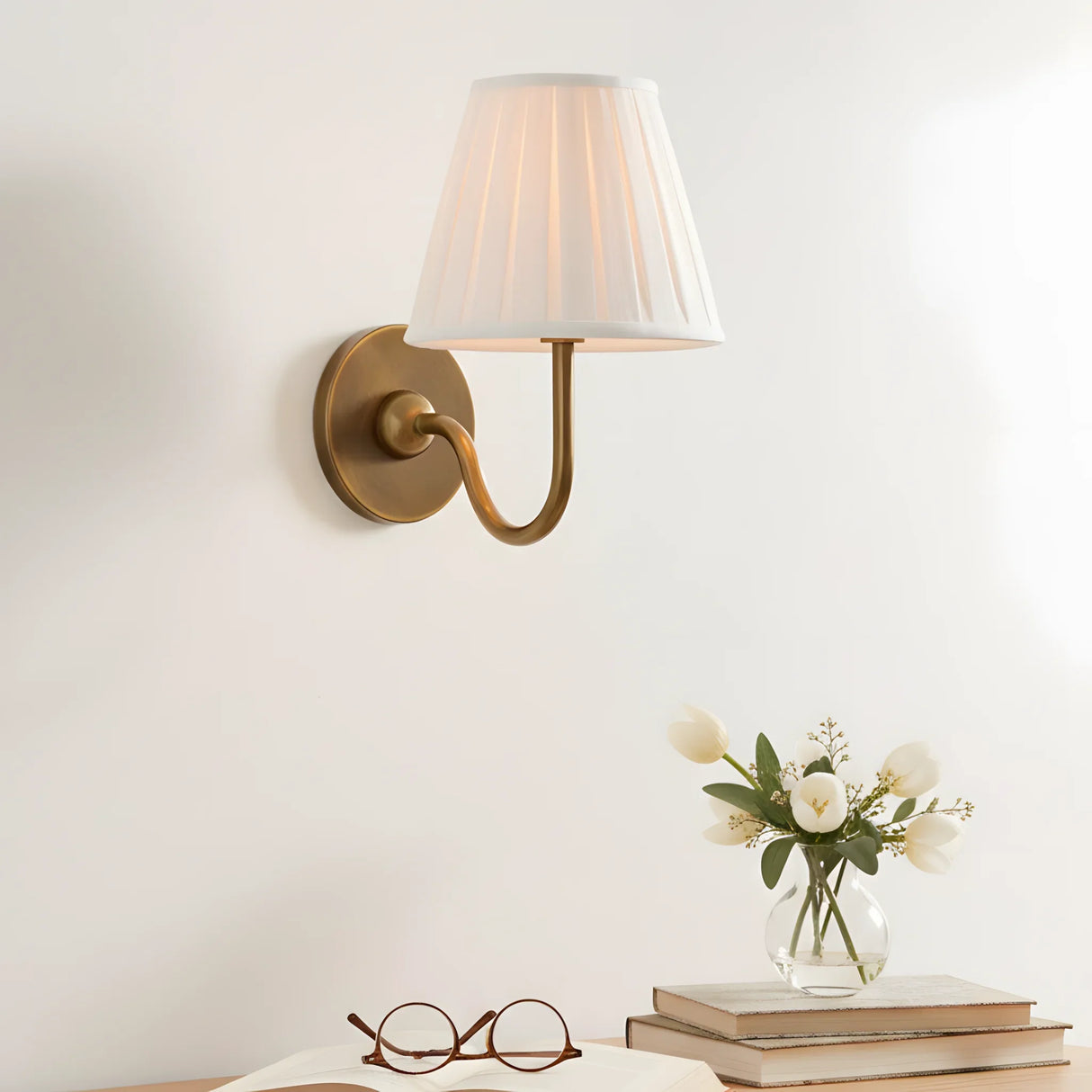 Brass-finish wall sconce with softly pleated fabric shade for indoor walls, sage green shade close-up 8