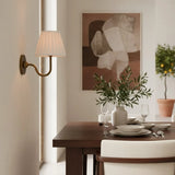Rustic metal wall sconce with pleated shade against a neutral backdrop, dusty blue shade lit shot 15