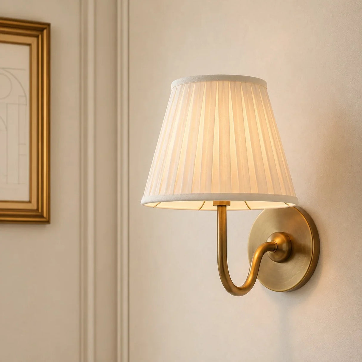 Rustic pleated fabric wall sconce with curved metal arm and round backplate, white shade front view 1