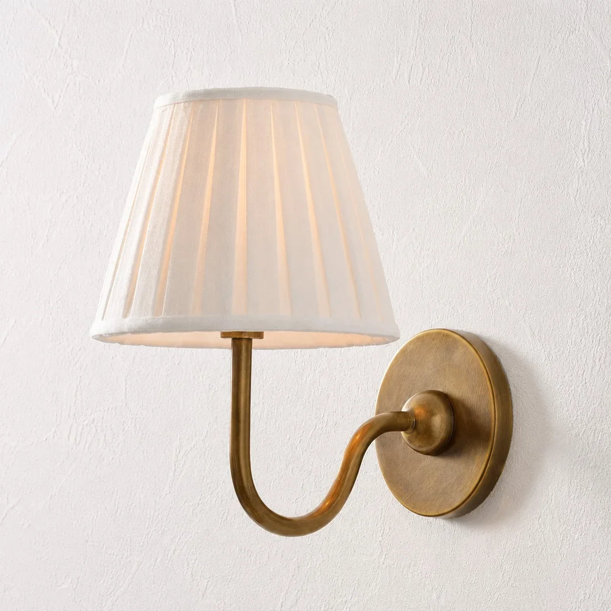 Single-head wall sconce with tapered pleated fabric shade and warm bulb glow, dusty blue shade angled view 33