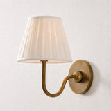 Single-head wall sconce with tapered pleated fabric shade and warm bulb glow, dusty blue shade angled view 33
