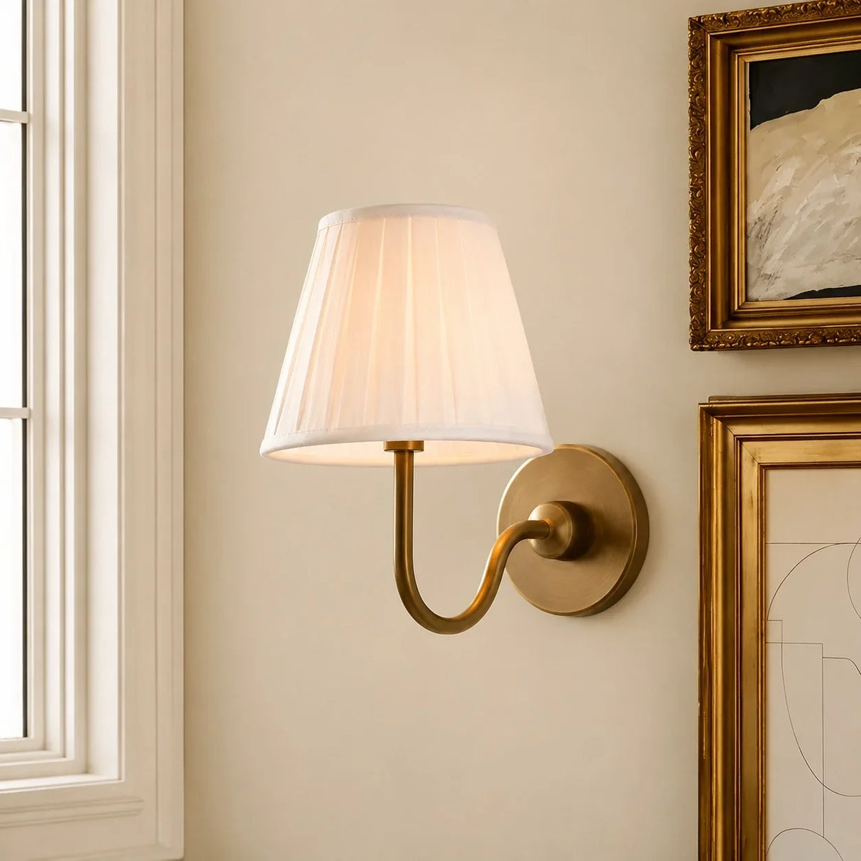 Pleated linen shade wall sconce shown against a plain studio background, sage green shade side view 2