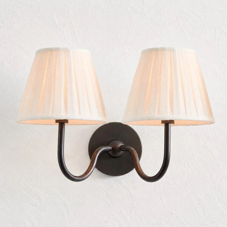 Detail of the round backplate and curved arm on the pleated fabric sconce, dusty blue shade product shot 27