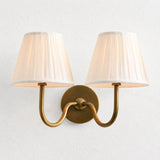 Rustic indoor wall sconce lit to show the warm glow through the linen shade, sage green shade styled shot 26