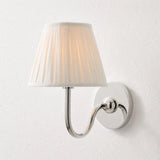 Rustic metal wall sconce with pleated shade against a neutral backdrop, green shade catalogue image 30