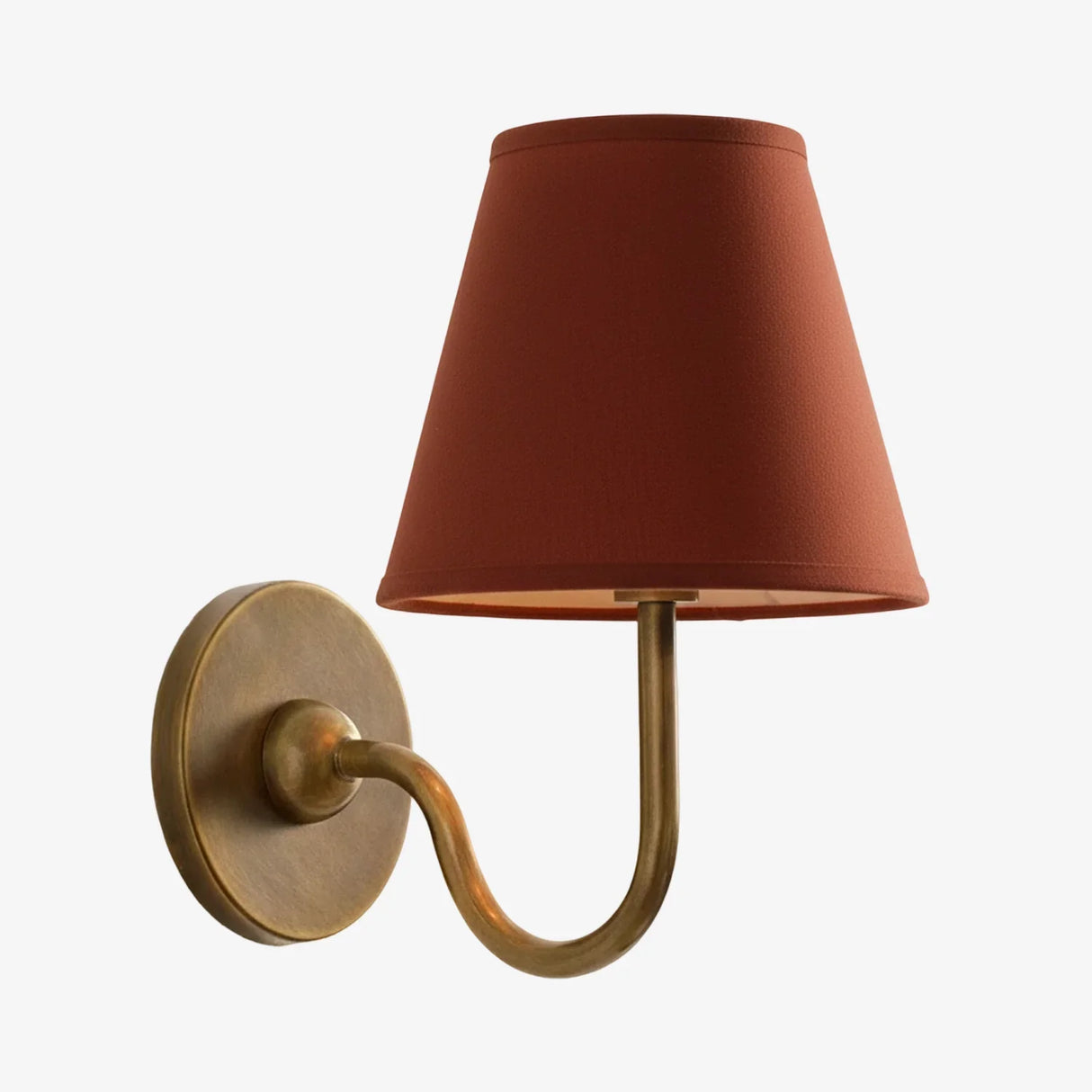 Rustic indoor wall sconce lit to show the warm glow through the linen shade, red shade front view 41
