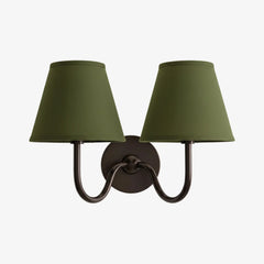 Close view of the pleated fabric shade and diffused warm light on the sconce, sage green shade catalogue image 50