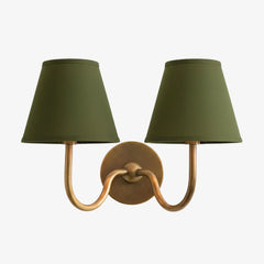Single-head wall sconce with tapered pleated fabric shade and warm bulb glow, green shade close-up 48