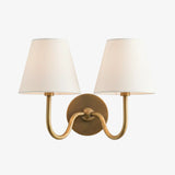 Close view of the pleated fabric shade and diffused warm light on the sconce, red shade lit shot 35