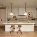 Cream opal glass pendant light against a dark backdrop