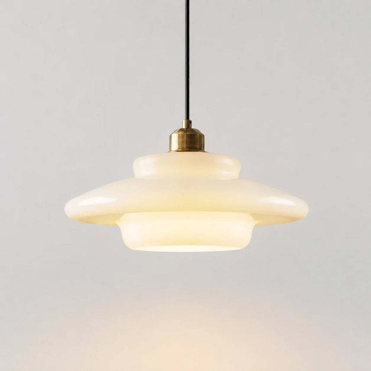 Cream opal glass pendant light on a plain background