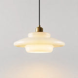 Cream opal glass pendant light on a plain background