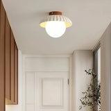 Front view of the scalloped shade ceiling light with frosted glass globe
