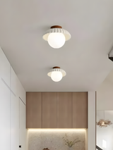 Close view of the ruffled petal shade above the round opal glass diffuser