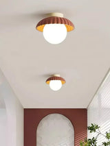 Angled view of the cream flush mount ceiling light and metal canopy