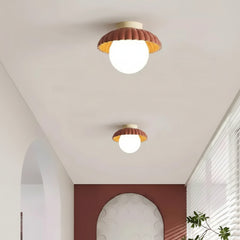 Angled view of the cream flush mount ceiling light and metal canopy