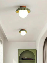 Modern glass flush mount ceiling light seen from below when lit