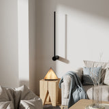Single angled black LED wall lamp above a cream sofa