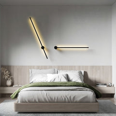 Two angled black wall lights above a bed with a wooden headboard