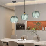 Modern bohemian living room lit by a green textured glass globe pendant light