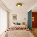 Glass disc light mounted flat on a wall
